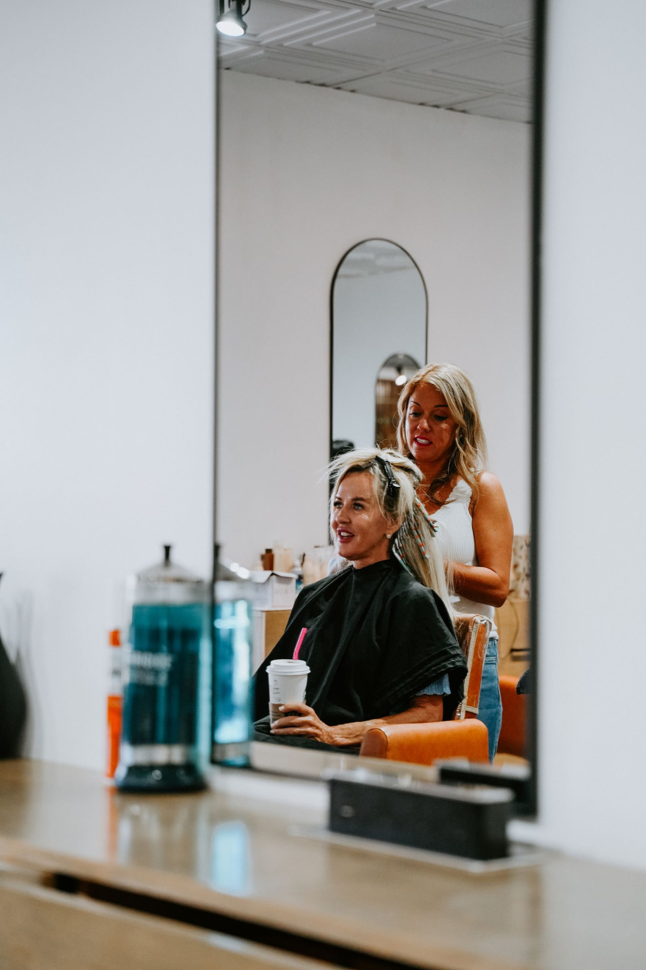 Stylist and client during a consultation at Blur. Salon + Extension Bar in Oklahoma City